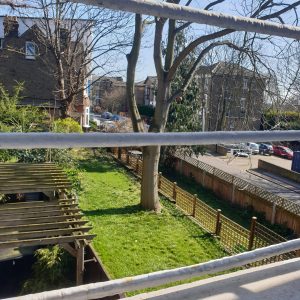 View of gardens and a road through window bars.