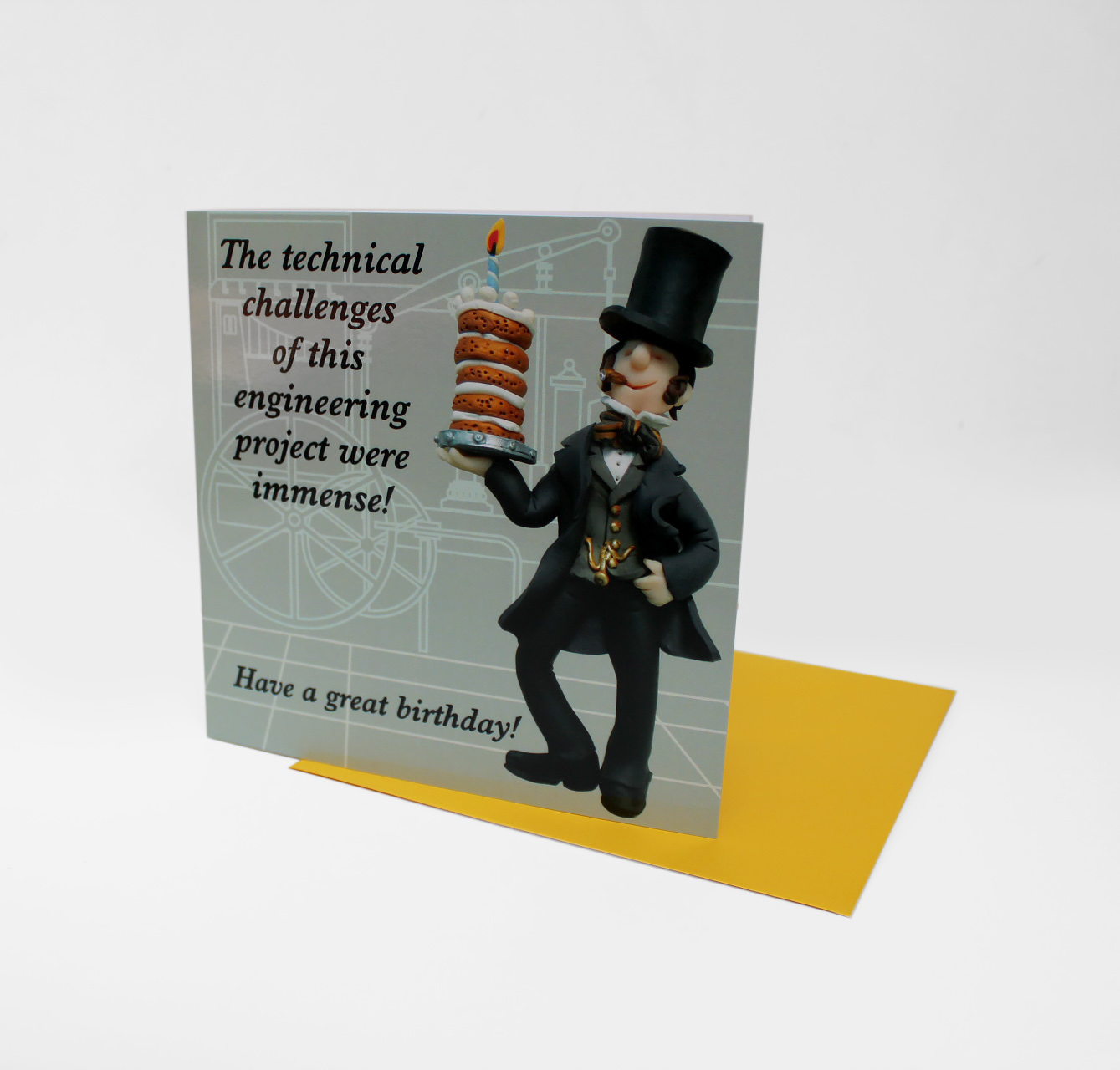 Birthday card featuring fun version of IKB holding a very tall cake. The text reads "The technical challenges of this engineering project were immense! Have a great birthday!"